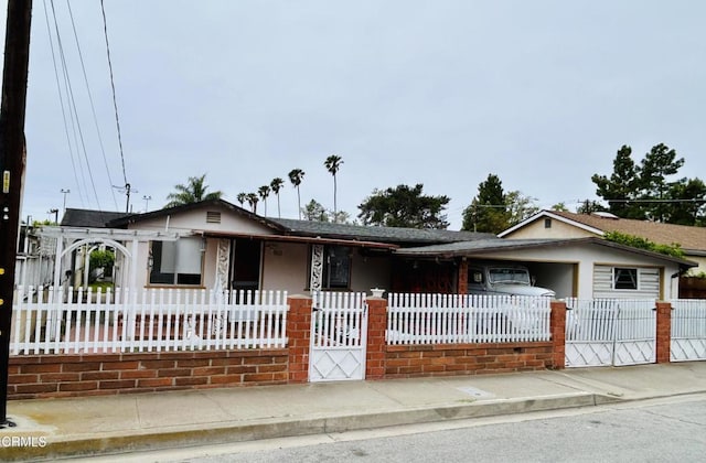 5021 Alvarado St, Carpinteria, CA 93013 - view of front of home featuring a fenced front yard, a shingled roof, and a porch