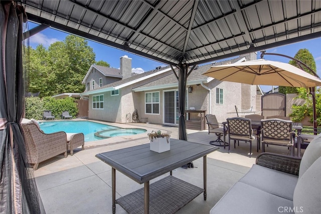 27702 Quincy St, Castaic, CA 91384 - view of patio / terrace featuring outdoor dining area, a storage unit, and a pool with connected hot tub