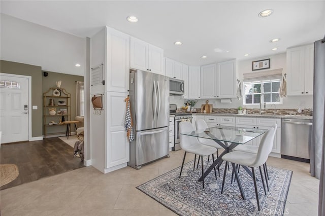 27702 Quincy St, Castaic, CA 91384 - kitchen featuring stainless steel appliances, a sink, white cabinetry, recessed lighting, and light tile patterned floors