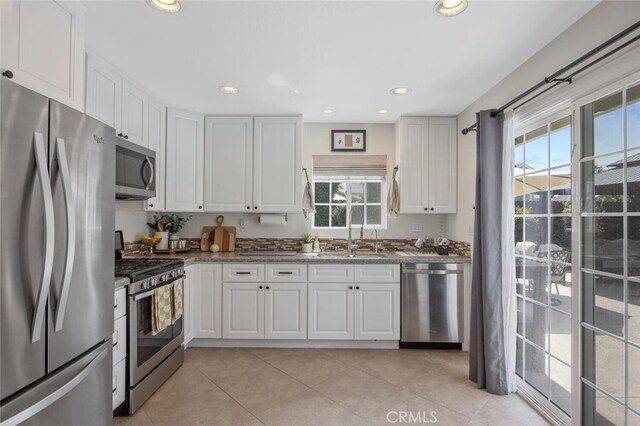 27702 Quincy St, Castaic, CA 91384 - kitchen with appliances with stainless steel finishes, a sink, healthy amount of natural light, white cabinets, and recessed lighting