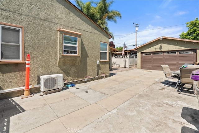 1876 Oregon Ave, Long Beach, CA 90806 - view of patio with ac unit, an outbuilding, and a detached garage