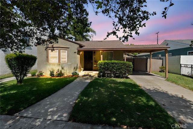 1876 Oregon Ave, Long Beach, CA 90806 - view of front of property featuring stucco siding, concrete driveway, and an attached carport