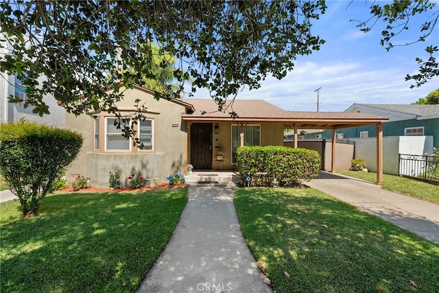 1876 Oregon Ave, Long Beach, CA 90806 - view of front of home featuring stucco siding, driveway, and a carport