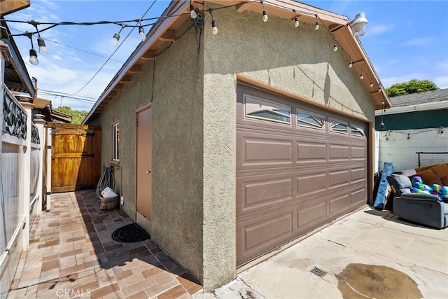 1876 Oregon Ave, Long Beach, CA 90806 - view of side of home with stucco siding, a garage, and an outdoor structure