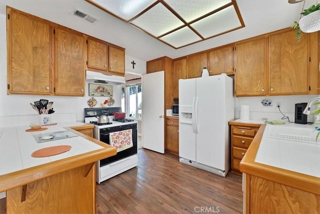 6713 Coral Ct, Rancho Cucamonga, CA 91701 - kitchen featuring white appliances, under cabinet range hood, tile counters, a sink, and brown cabinetry