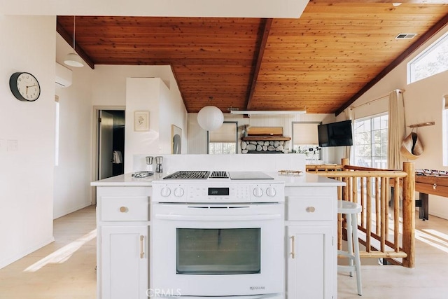 960 Butte Ave, Big Bear City, CA 92314 - kitchen with white electric range oven, wood ceiling, healthy amount of natural light, white cabinets, and vaulted ceiling