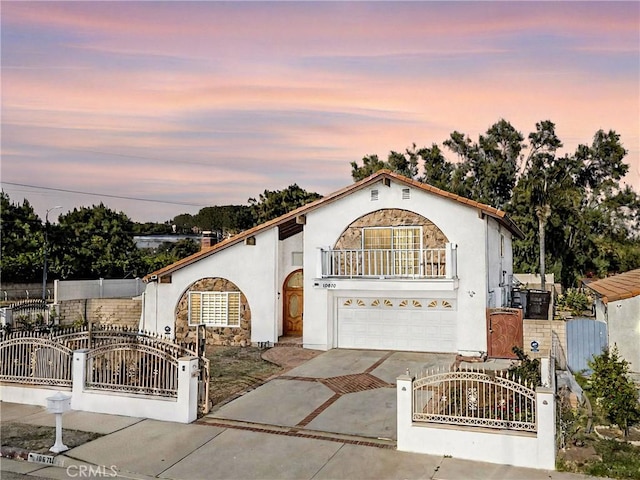 10670 Deering Ave, Chatsworth, CA 91311 - mediterranean / spanish-style home with driveway, an attached garage, a gate, and a fenced front yard