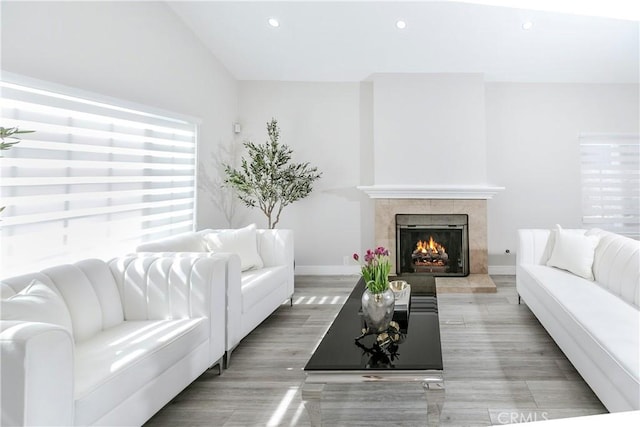 10670 Deering Ave, Chatsworth, CA 91311 - living area with recessed lighting, a tile fireplace, light wood-type flooring, and baseboards