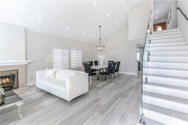 10670 Deering Ave, Chatsworth, CA 91311 - living area featuring high vaulted ceiling, stairway, light wood-type flooring, baseboards, and recessed lighting