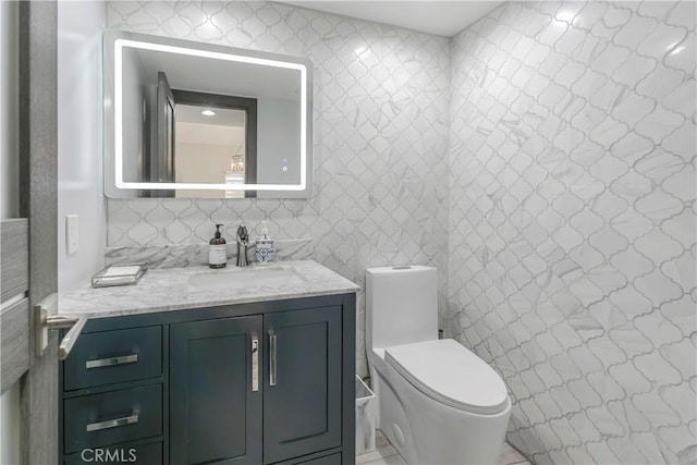 10670 Deering Ave, Chatsworth, CA 91311 - bathroom featuring toilet, vanity, and tile walls
