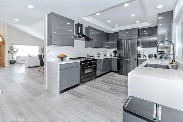 10670 Deering Ave, Chatsworth, CA 91311 - kitchen featuring freestanding refrigerator, high end black range, wall chimney range hood, gray cabinetry, and modern cabinets