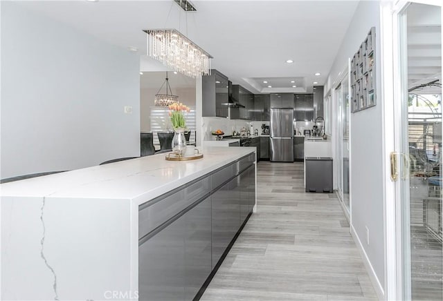 10670 Deering Ave, Chatsworth, CA 91311 - kitchen featuring modern cabinets, freestanding refrigerator, gray cabinetry, a chandelier, and hanging light fixtures