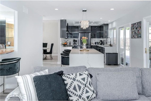 10670 Deering Ave, Chatsworth, CA 91311 - living area featuring a chandelier, light wood finished floors, baseboards, and recessed lighting