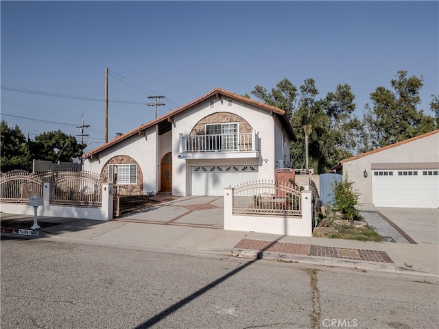 10670 Deering Ave, Chatsworth, CA 91311 - mediterranean / spanish house featuring a balcony, a gate, stucco siding, and driveway