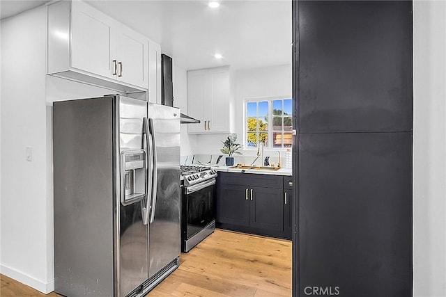 401 W Poplar St, Compton, CA 90220 - kitchen with appliances with stainless steel finishes, light wood-style floors, white cabinets, recessed lighting, and light countertops