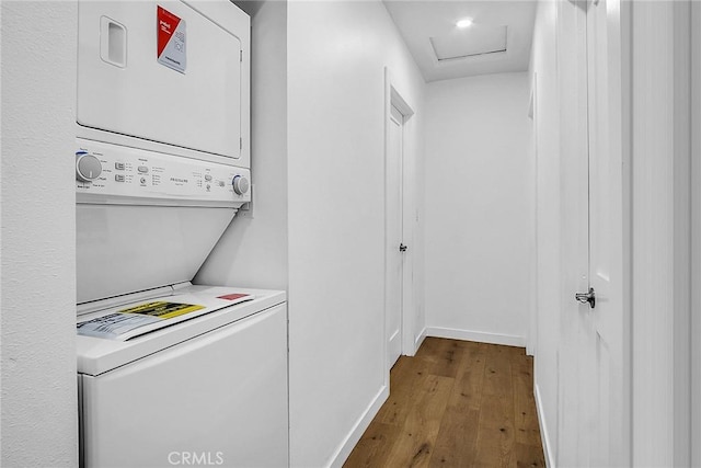 401 W Poplar St, Compton, CA 90220 - washroom featuring stacked washing machine and dryer, wood finished floors, and attic access