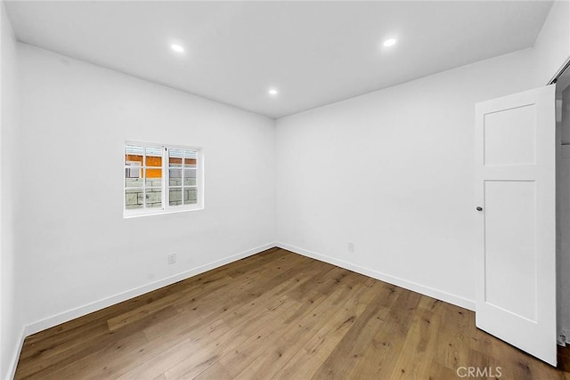 401 W Poplar St, Compton, CA 90220 - unfurnished room featuring hardwood / wood-style floors, recessed lighting, and baseboards
