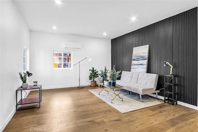 401 W Poplar St, Compton, CA 90220 - sitting room featuring wood finished floors, recessed lighting, an accent wall, and a wall unit AC