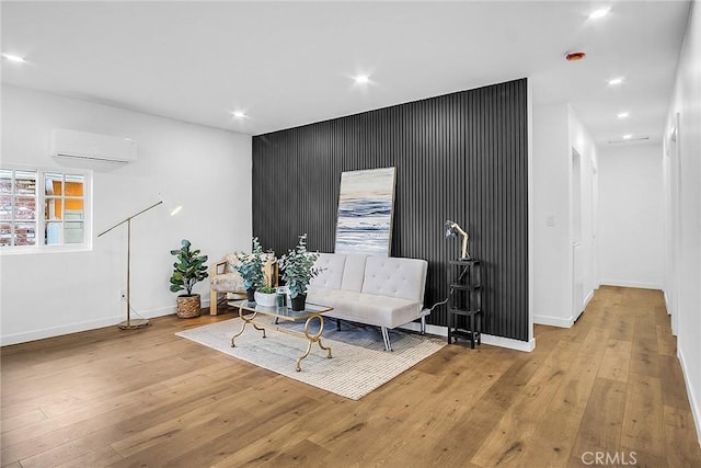 401 W Poplar St, Compton, CA 90220 - sitting room featuring a wall mounted AC, light wood finished floors, an accent wall, and recessed lighting