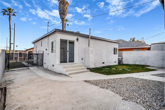 401 W Poplar St, Compton, CA 90220 - back of property with stucco siding, a patio area, crawl space, and entry steps