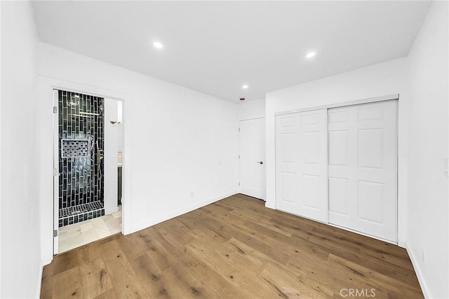 401 W Poplar St, Compton, CA 90220 - unfurnished bedroom with wood finished floors, recessed lighting, baseboards, and a closet