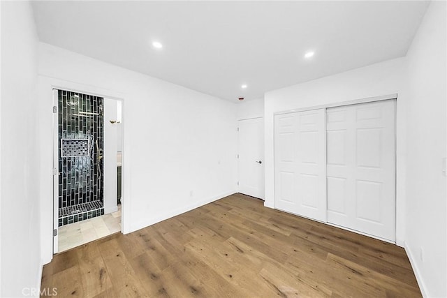 401 W Poplar St, Compton, CA 90220 - unfurnished bedroom featuring wood finished floors, recessed lighting, and a closet