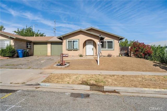 42045 Thornbush Ave, Lancaster, CA 93536 - view of front of home featuring an attached garage, stucco siding, and driveway