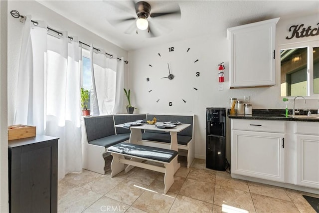 42045 Thornbush Ave, Lancaster, CA 93536 - kitchen with a sink, ceiling fan, white cabinets, and dark stone countertops