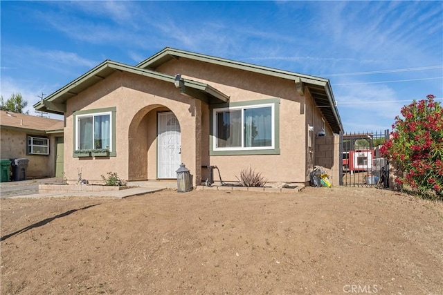 42045 Thornbush Ave, Lancaster, CA 93536 - bungalow-style house with stucco siding and a gate