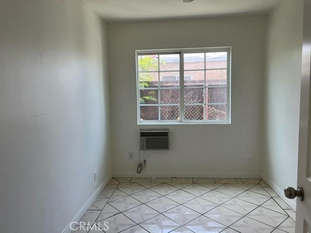 12760 Judd St, Pacoima, CA 91331 - empty room featuring a wall mounted air conditioner and baseboards