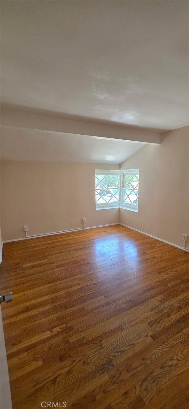 16718 Gledhill St, Northridge, CA 91343 - unfurnished room featuring wood finished floors, vaulted ceiling, and baseboards