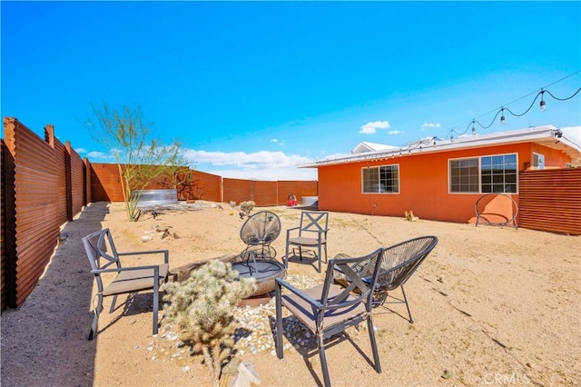 55850 Shannon Rd, Landers, CA 92285 - fenced backyard featuring an outdoor fire pit