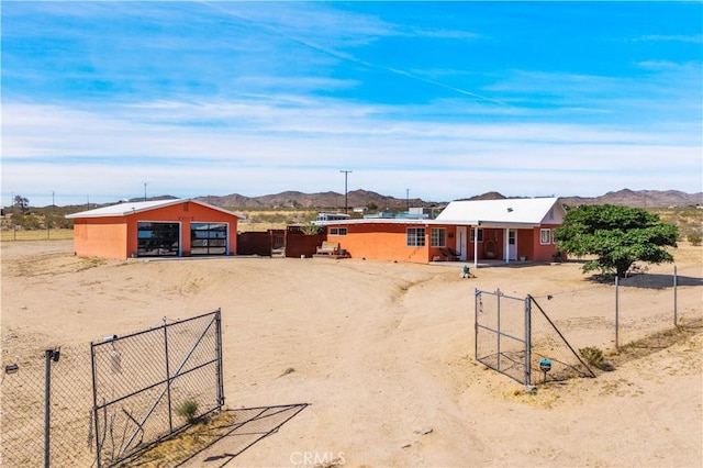 55850 Shannon Rd, Landers, CA 92285 - view of yard featuring driveway, a detached garage, a mountain view, and an outdoor structure