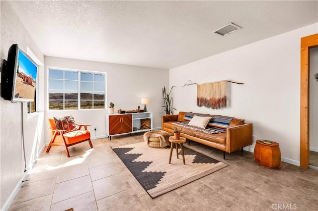 55850 Shannon Rd, Landers, CA 92285 - living area with a textured ceiling, baseboards, and tile patterned flooring