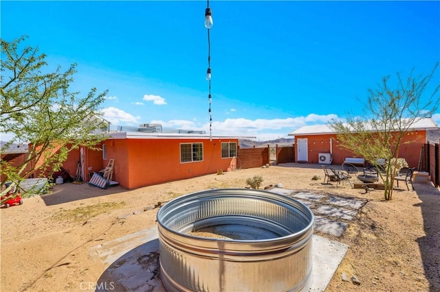 55850 Shannon Rd, Landers, CA 92285 - back of property featuring a fire pit and stucco siding