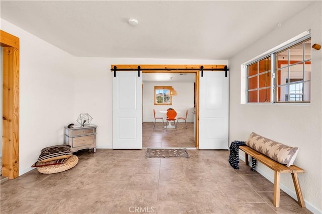55850 Shannon Rd, Landers, CA 92285 - entryway with a barn door, baseboards, and tile patterned flooring