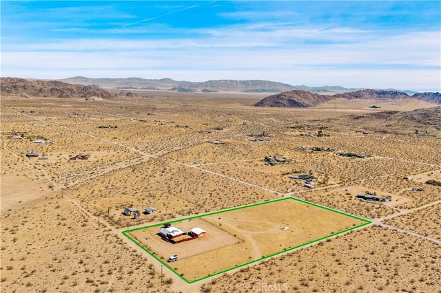 55850 Shannon Rd, Landers, CA 92285 - aerial view of sparsely populated area with a mountain backdrop, a desert landscape, and property parcel outlined
