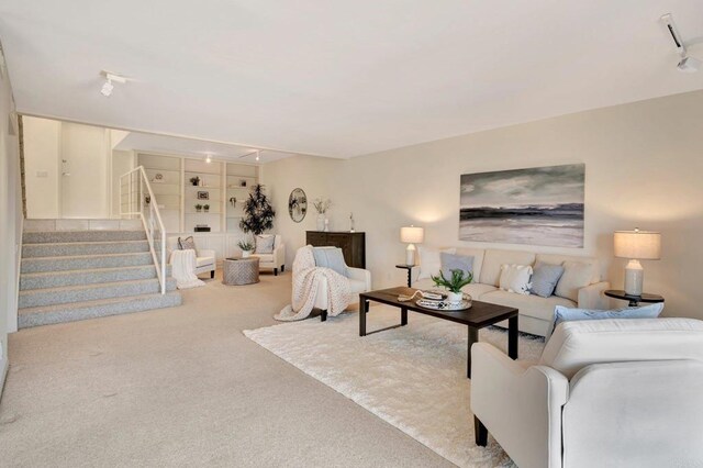 55 Jasmine Creek Dr, Corona Del Mar, CA 92625 - carpeted living room featuring rail lighting, stairs, and built in shelves