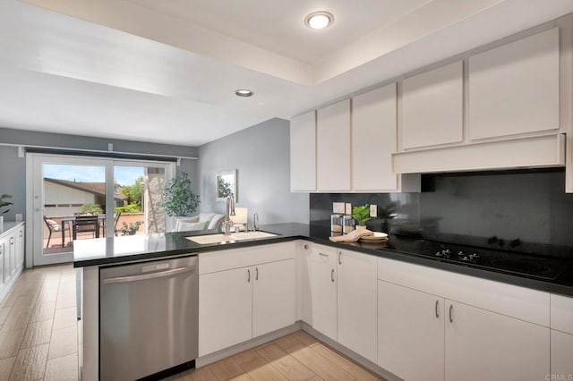 55 Jasmine Creek Dr, Corona Del Mar, CA 92625 - kitchen featuring stainless steel dishwasher, black electric stovetop, a peninsula, dark countertops, and white cabinetry
