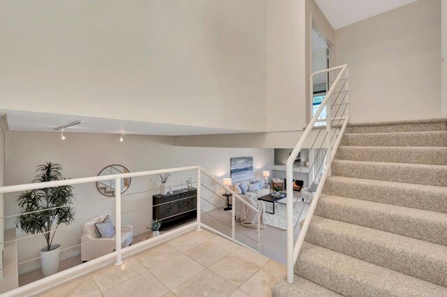 55 Jasmine Creek Dr, Corona Del Mar, CA 92625 - staircase featuring tile patterned flooring and rail lighting