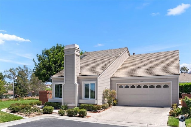 23232 El Greco, Mission Viejo, CA 92692 - view of front of house featuring concrete driveway, a garage, a tiled roof, and a chimney