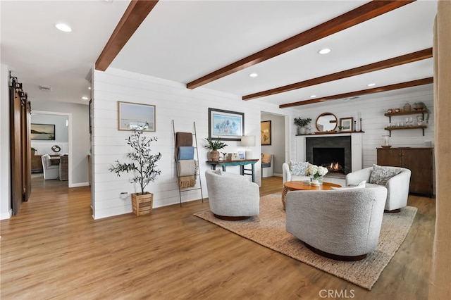 3061 Ruth Elaine, Los Alamitos, CA 90720 - living room with wood finished floors, a warm lit fireplace, beam ceiling, wood walls, and recessed lighting