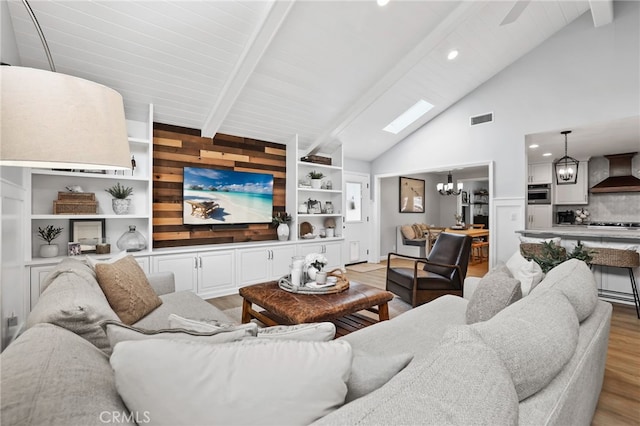 3061 Ruth Elaine, Los Alamitos, CA 90720 - living area with a chandelier, light wood-style flooring, beam ceiling, recessed lighting, and a skylight