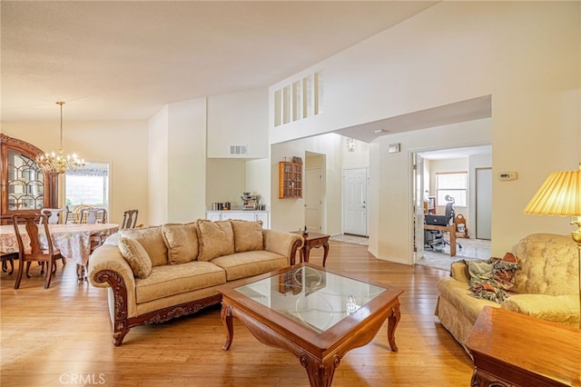 5340 Gardendale Ln, Palmdale, CA 93551 - living area with healthy amount of natural light, a chandelier, and light wood finished floors