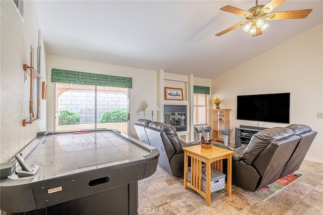 5340 Gardendale Ln, Palmdale, CA 93551 - living area with healthy amount of natural light, ceiling fan, lofted ceiling, and light stone finish flooring