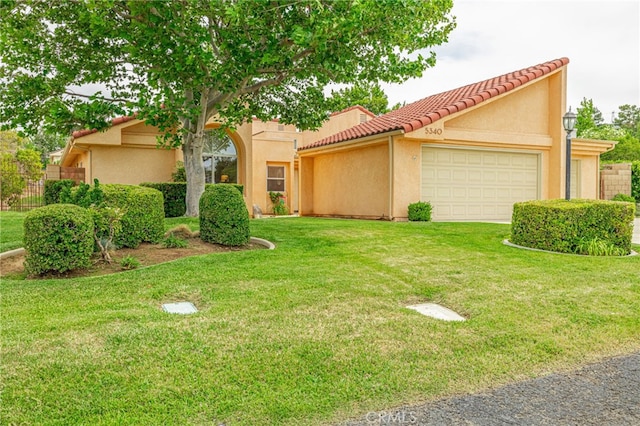 5340 Gardendale Ln, Palmdale, CA 93551 - view of front of property featuring an attached garage, a tile roof, and stucco siding