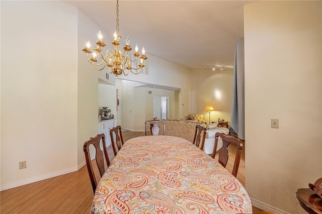5340 Gardendale Ln, Palmdale, CA 93551 - dining room featuring light wood-style floors, a chandelier, and baseboards