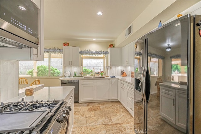 5340 Gardendale Ln, Palmdale, CA 93551 - kitchen with stainless steel appliances, a sink, light countertops, white cabinetry, and recessed lighting