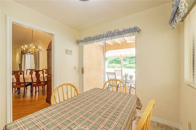 5340 Gardendale Ln, Palmdale, CA 93551 - dining room with a chandelier, wood finished floors, and baseboards