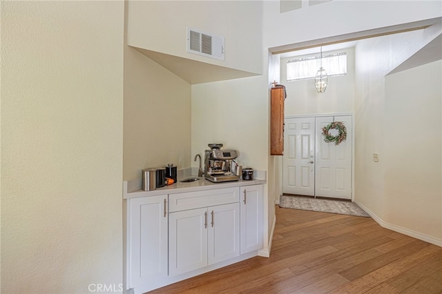 5340 Gardendale Ln, Palmdale, CA 93551 - entrance foyer featuring light wood finished floors, a chandelier, baseboards, and a towering ceiling